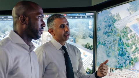 Two operators looking at a map-centric interface