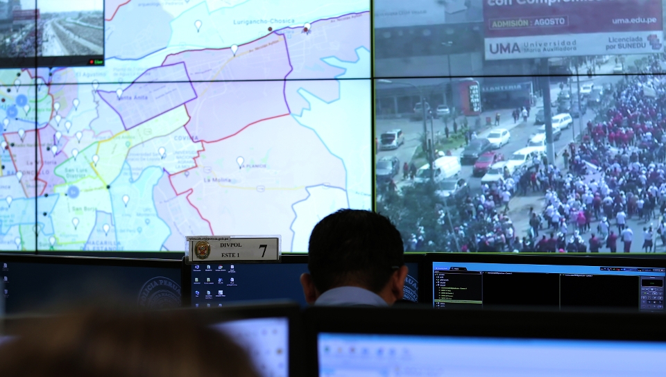 Security operator at his desk in front of a video wall